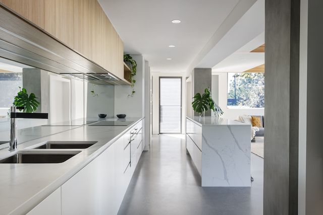 A Kitchen with Two Sinks and A Large Island in The Middle of The Room — DecoGlaze in Cardiff, NSW