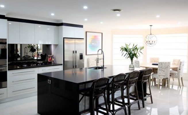 A Kitchen with A Large Island in The Middle and A Dining Room in The Background — DecoGlaze in Cardiff, NSW