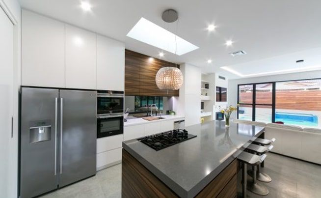 A Blue Car Is Parked on A City Street at Night — DecoGlaze in Cardiff, NSW