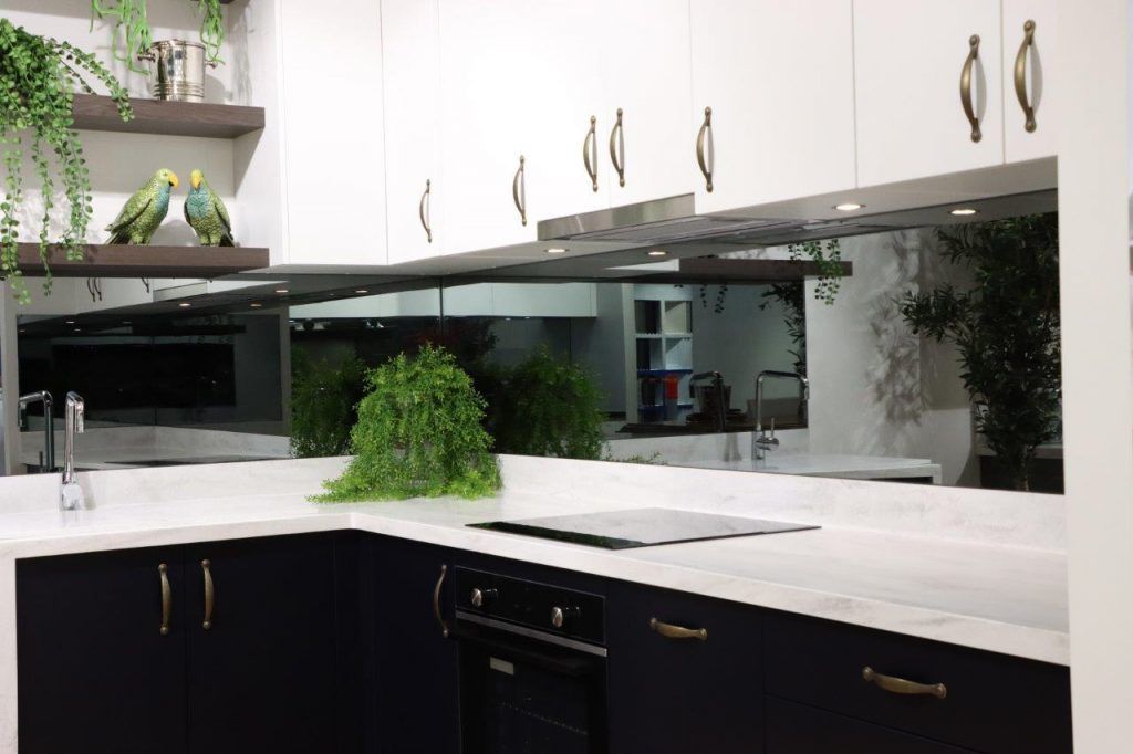 A Kitchen with Black Cabinets and A Large Mirror on The Wall — DecoGlaze in Singleton, NSW