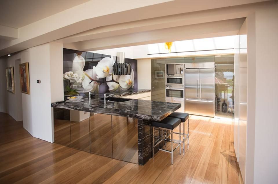 A Kitchen with A Large Island and Stainless Steel Appliances — DecoGlaze in Cessnock, NSW
