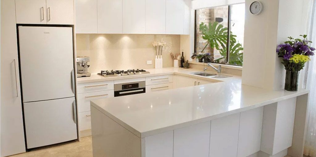 A Kitchen with White Cabinets, White Counter Tops , a Refrigerator and A Sink — DecoGlaze in Lake Macquarie, NSW