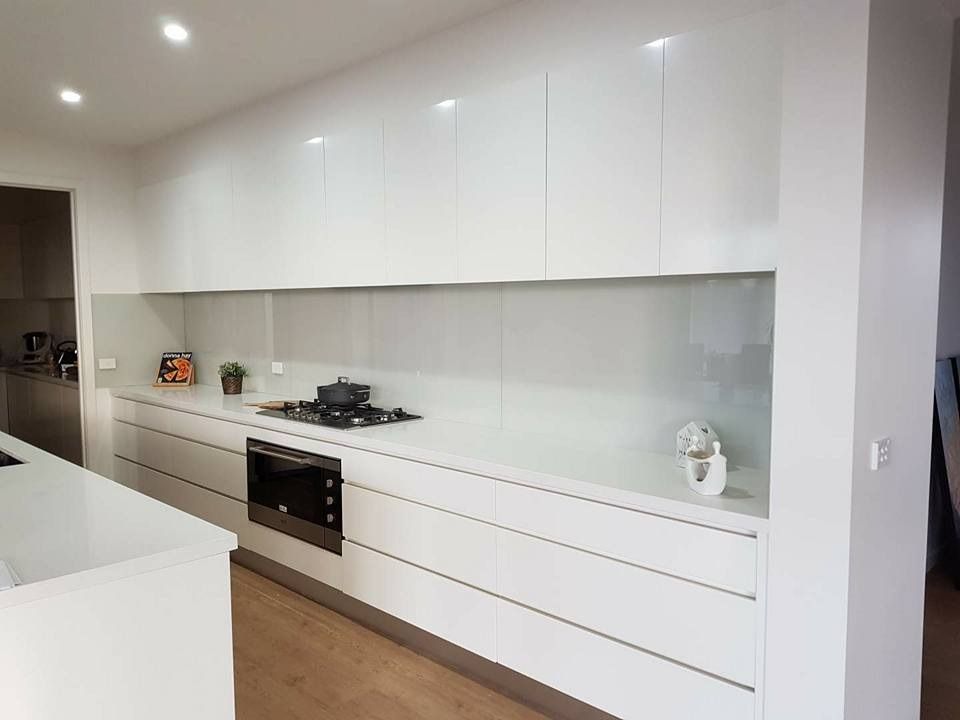 A Kitchen with White Cabinets , a Stove , a Microwave and A Sink — DecoGlaze in Cardiff, NSW