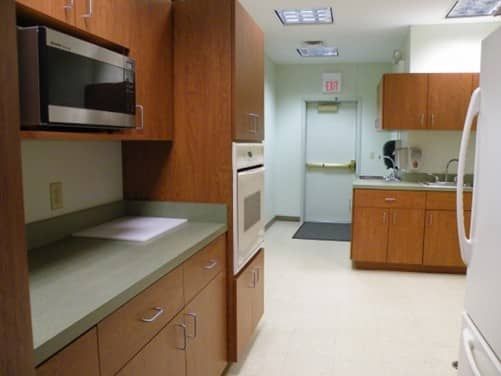 A kitchen with wooden cabinets and a white refrigerator