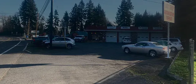 Outside of our shop, picture of our building with cars parked in front in Washington | Four Seasons Tire & Auto Service