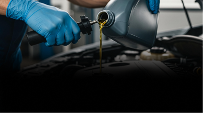 Technician performing oil change | Four Seasons Tire & Auto Service