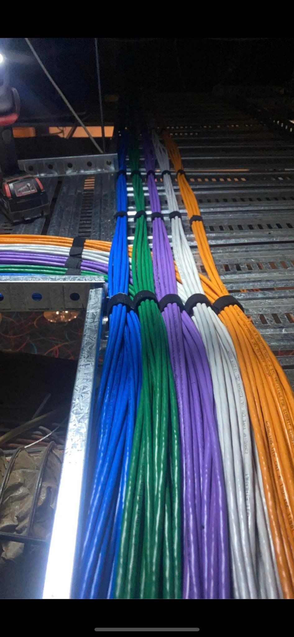 A bunch of colorful wires are hanging from the ceiling.