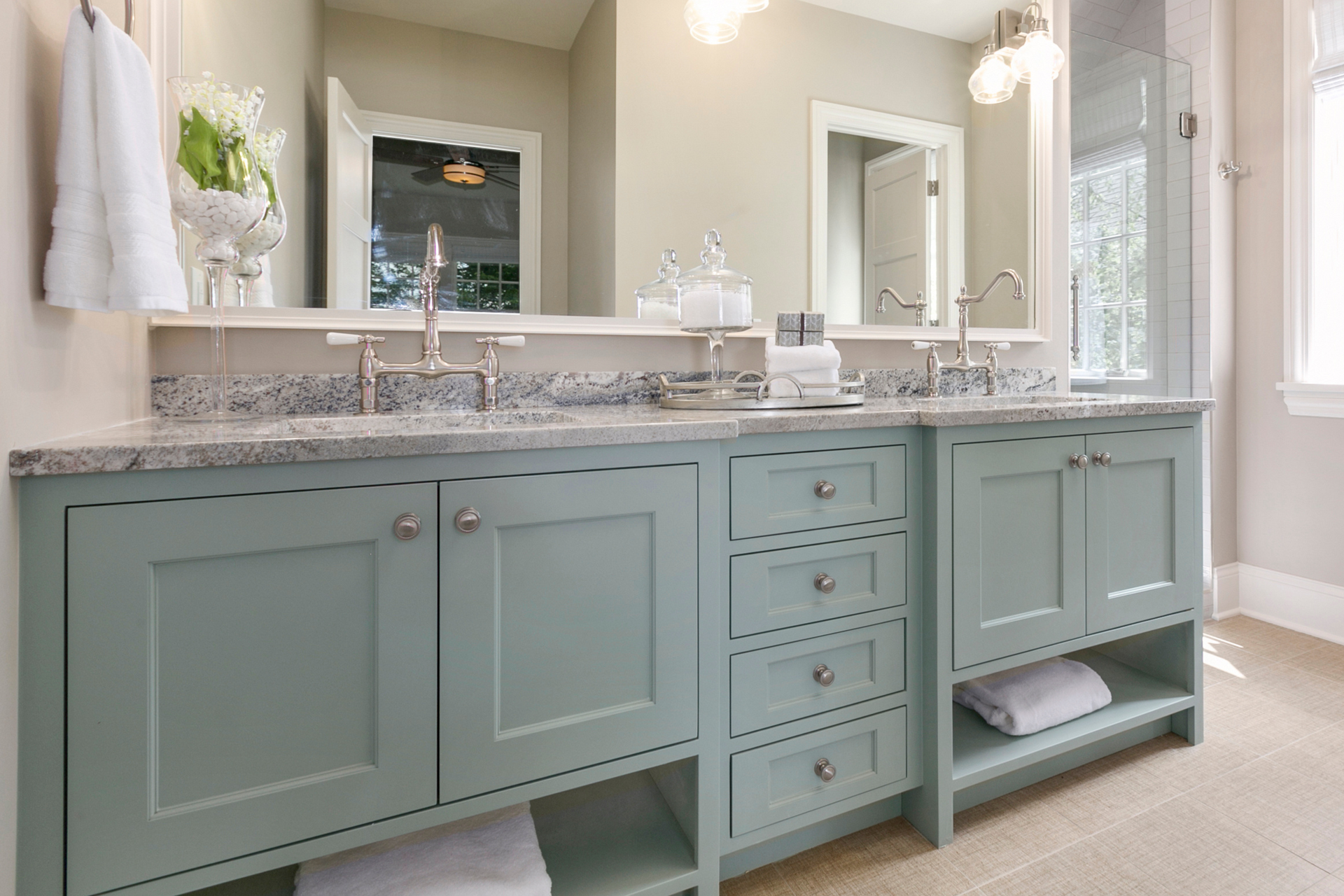 A bathroom with two sinks and two mirrors.