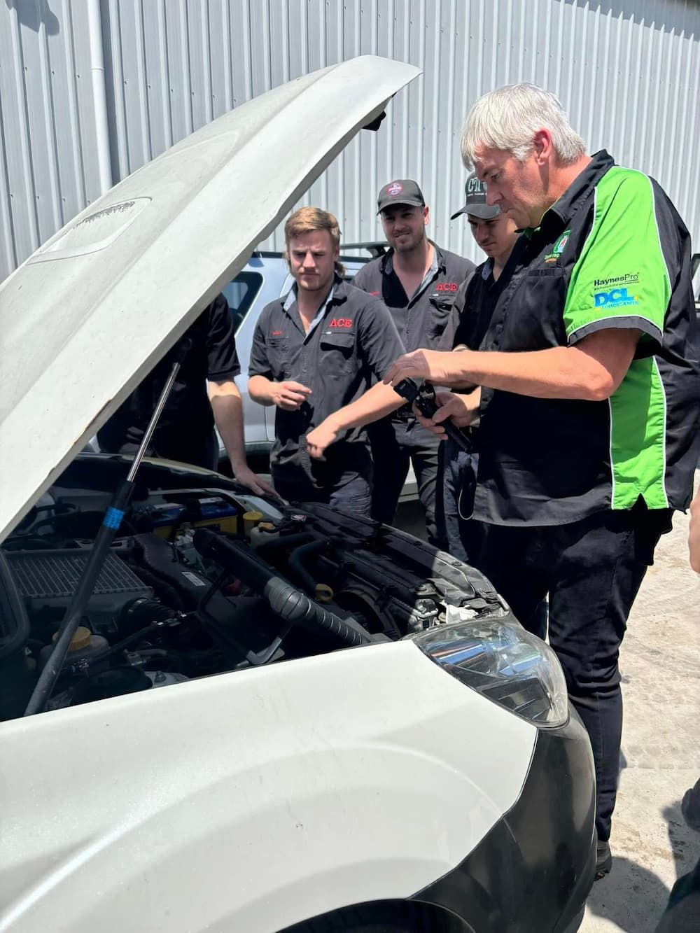 A Group of Mechanics in a Workshop
