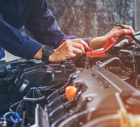 A Man Is Working On The Engine Of A Car — Ace-Marian In Marian, QLD
