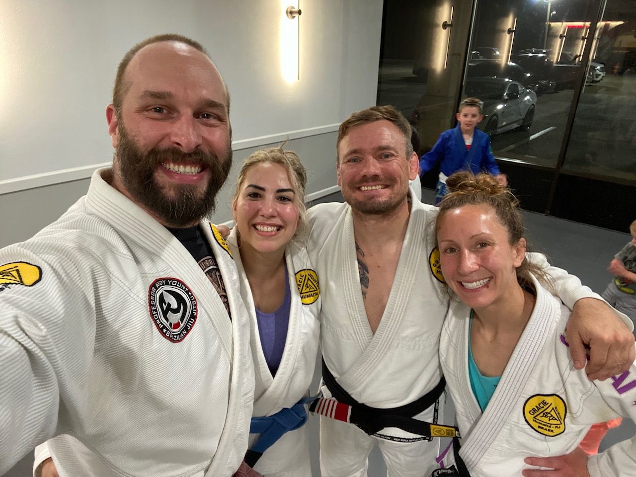 Adult men and women smiling after training.