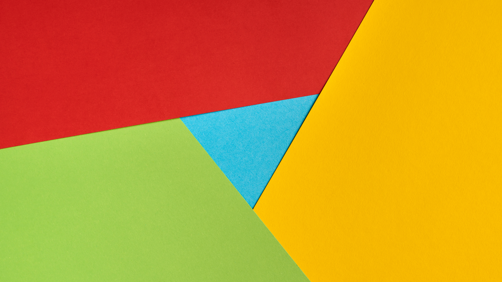 Abstract design with red, yellow, and green triangular segments surrounding a central light blue triangle.