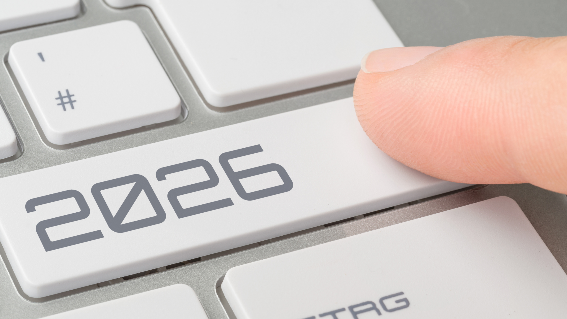 Finger pressing the keyboard key labeled 