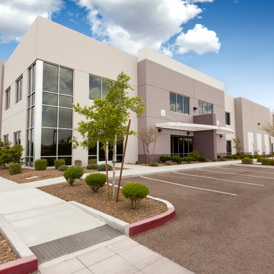 Modern, two-story commercial building with light gray and purple exterior.