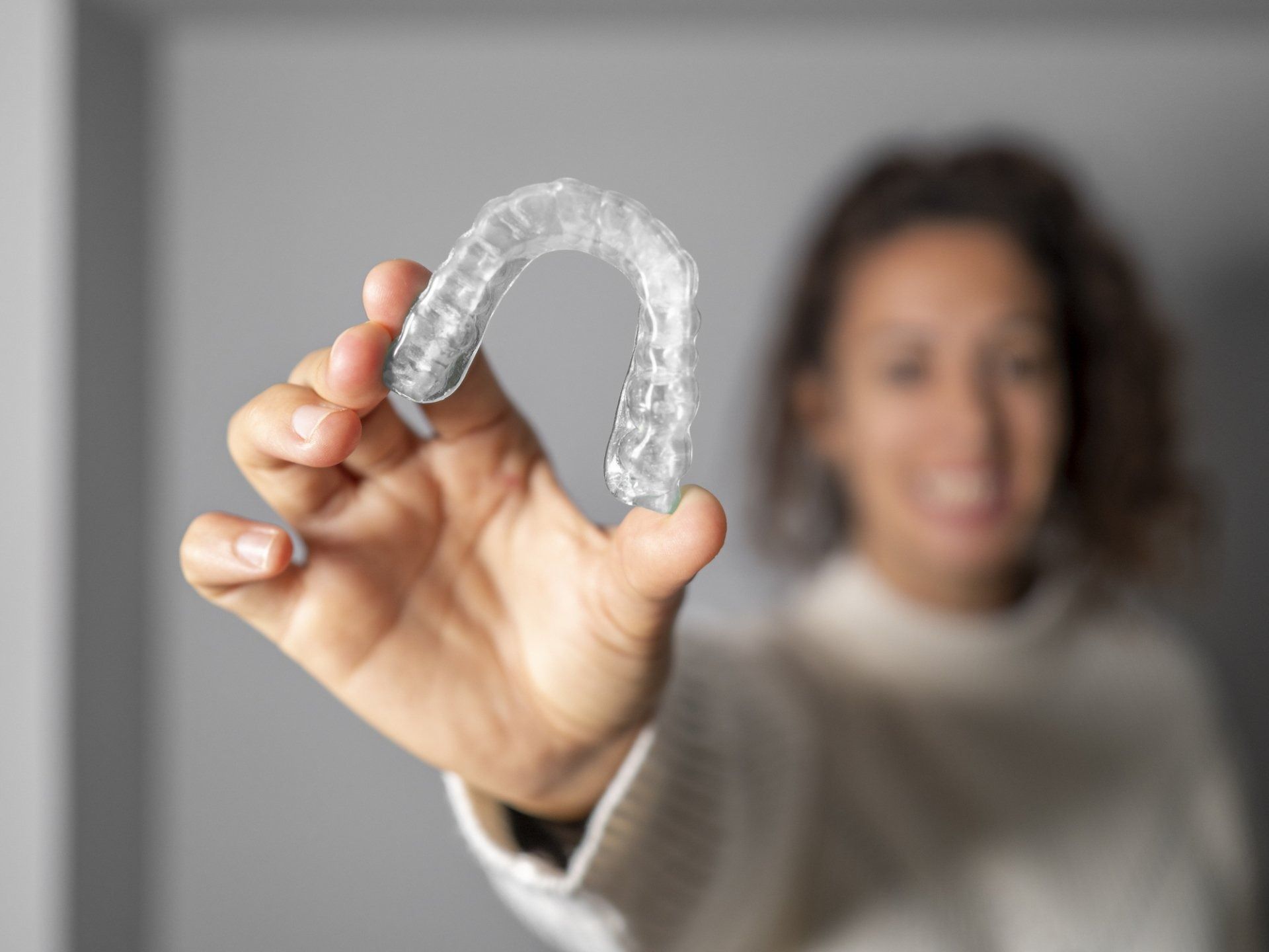 Woman Holding an Invisalign — Caldwell, ID — Webster Orthodontics