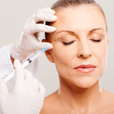 Woman getting a Botox injection. Woman getting a Botox injection.
