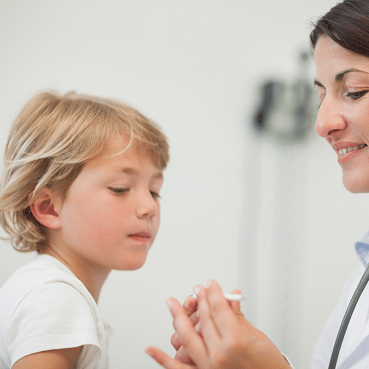 A child getting his temperature taken by a doctor.