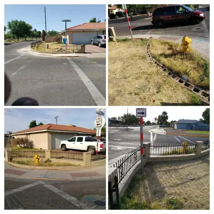 Sidewalk ramp at a street corner with metal railing, yellow fire hydrant, and curb cuts near a crosswalk.