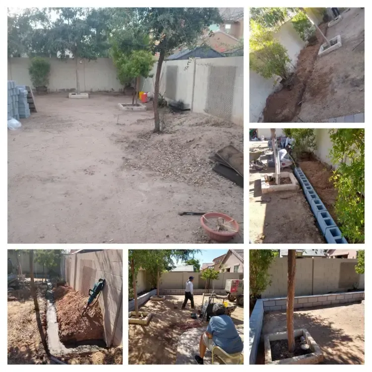 Backyard under construction with dirt ground, tools, pipes, and workers near a wall and trees