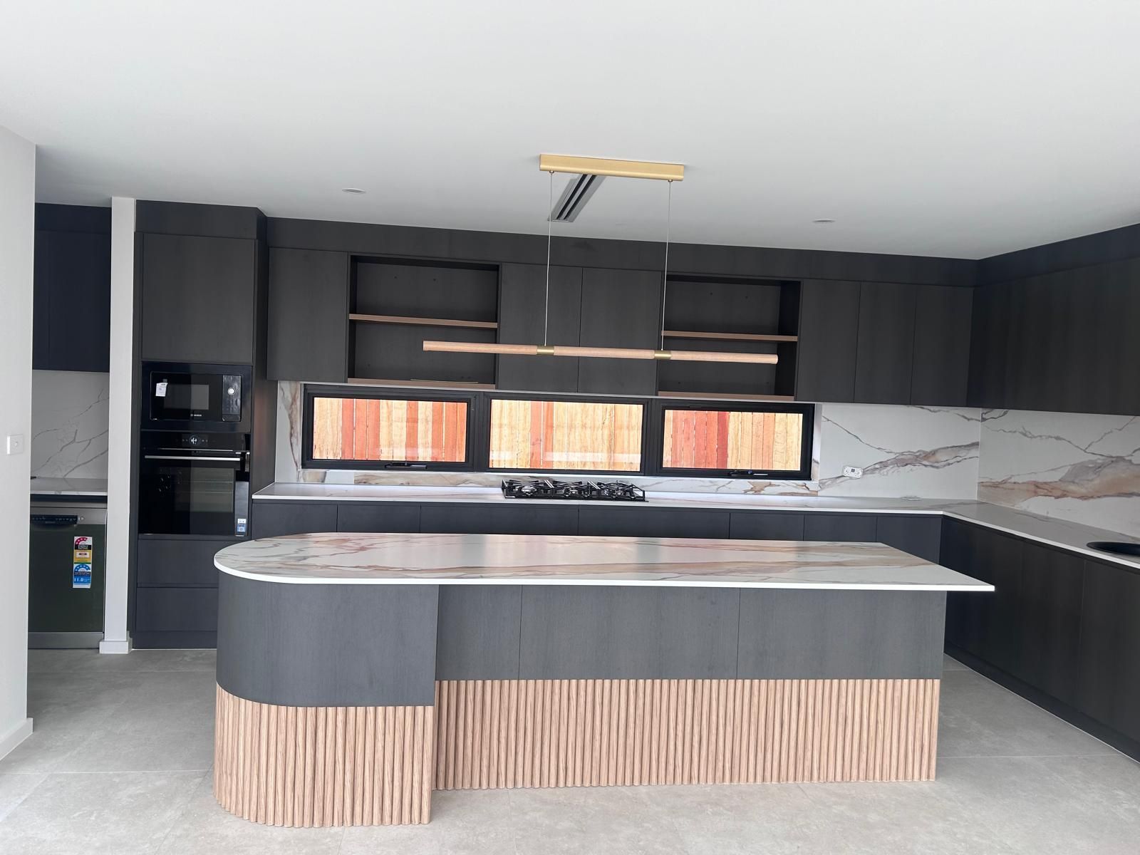 A kitchen with a large island in the middle of it.