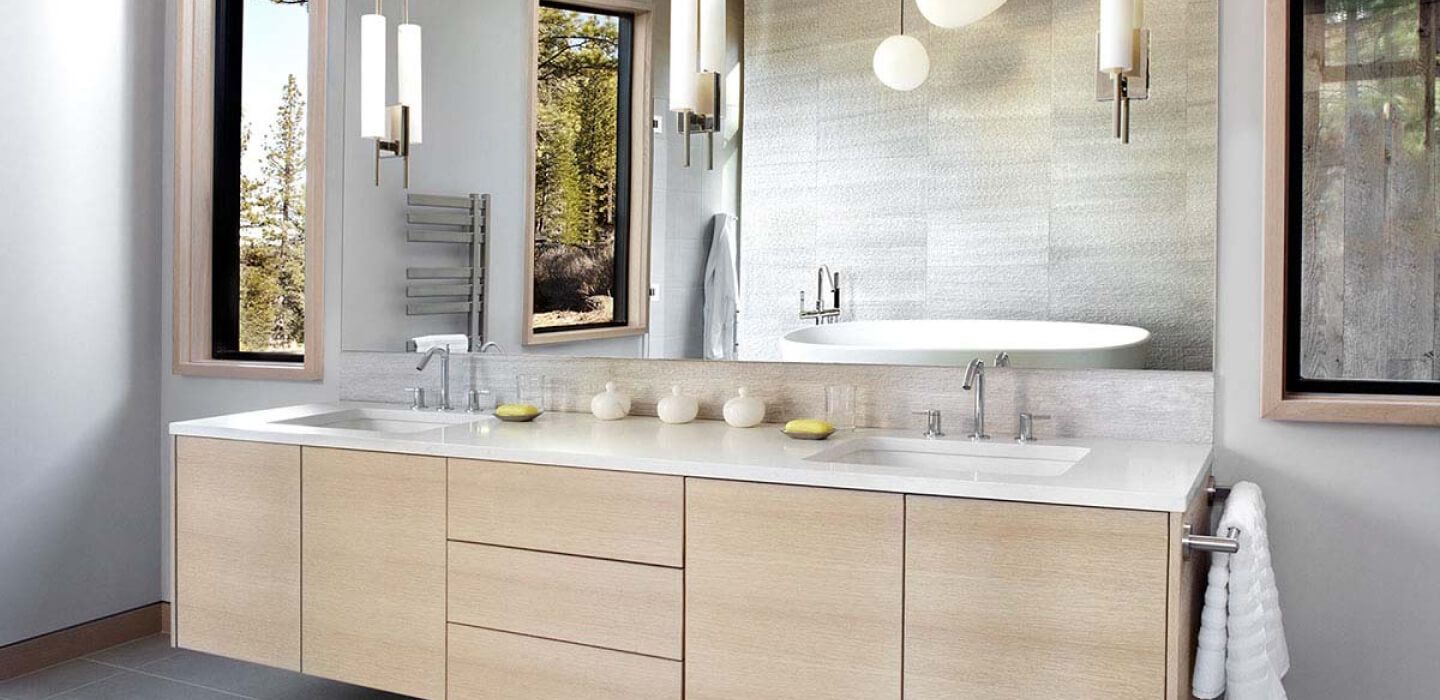 A bathroom with two sinks , two mirrors and a tub.