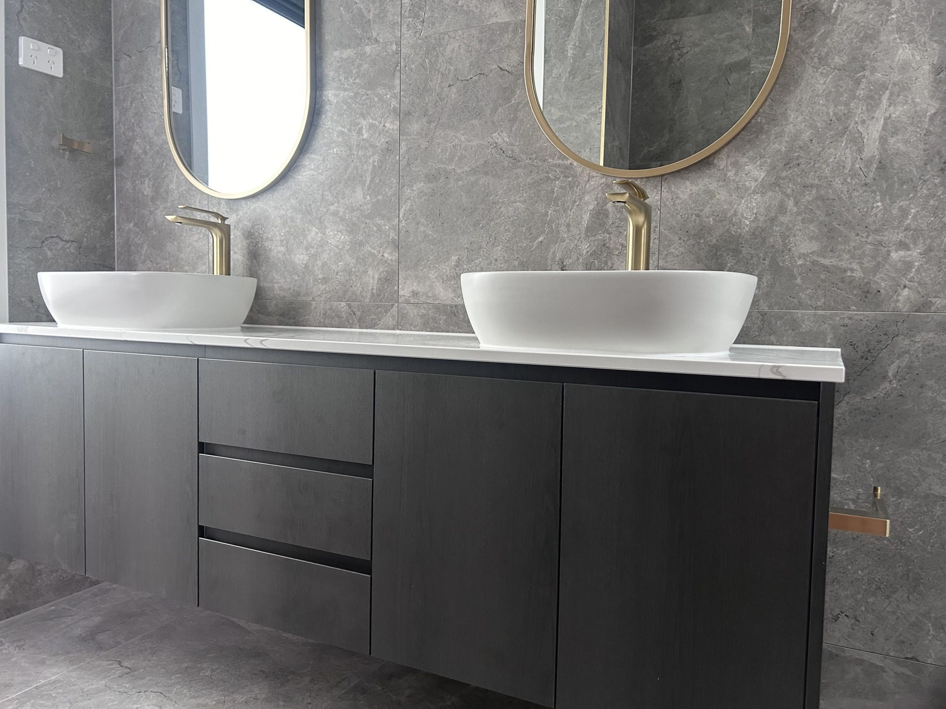 A bathroom with two sinks and two mirrors.