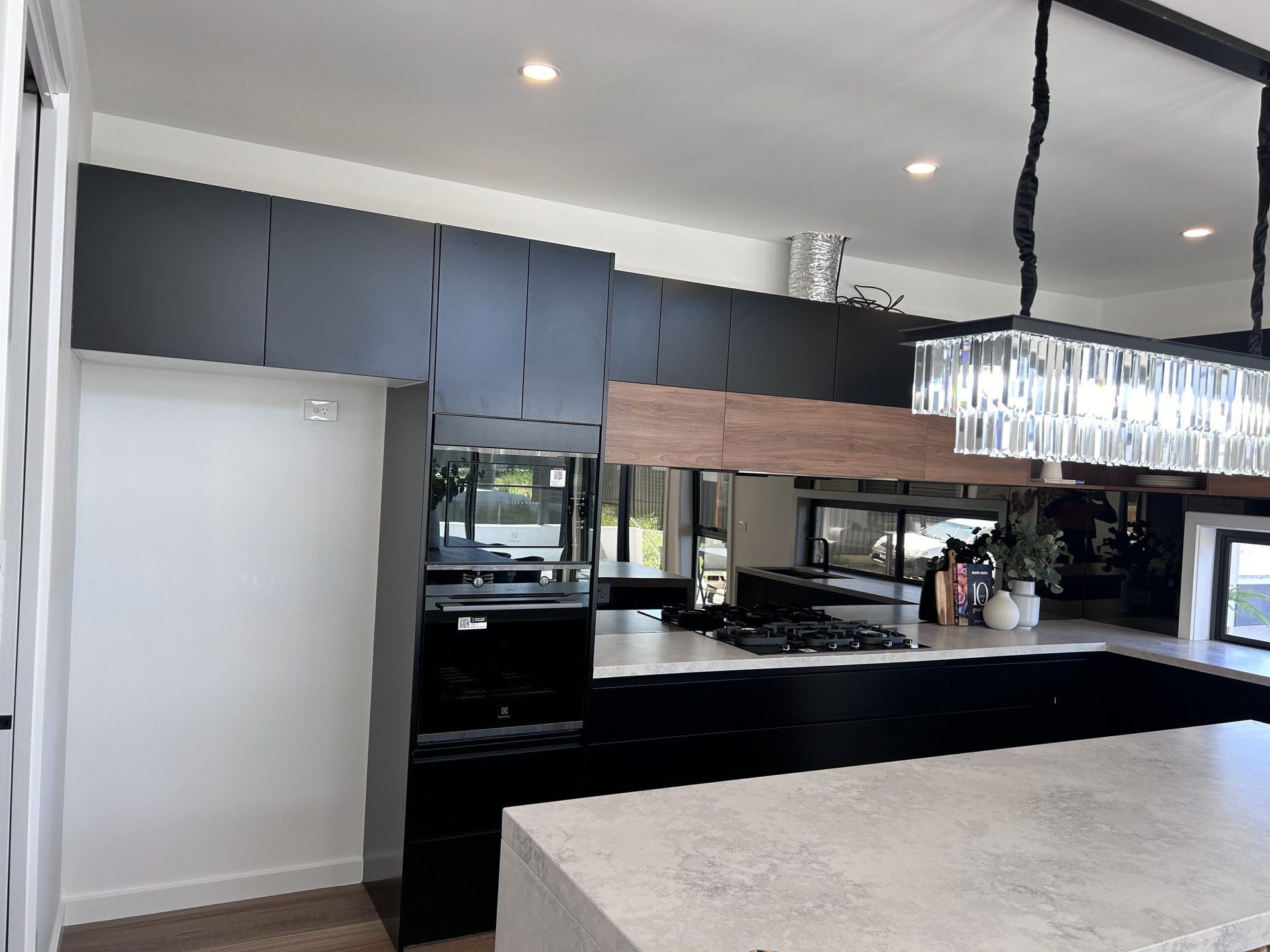 A kitchen with black cabinets and white counter tops
