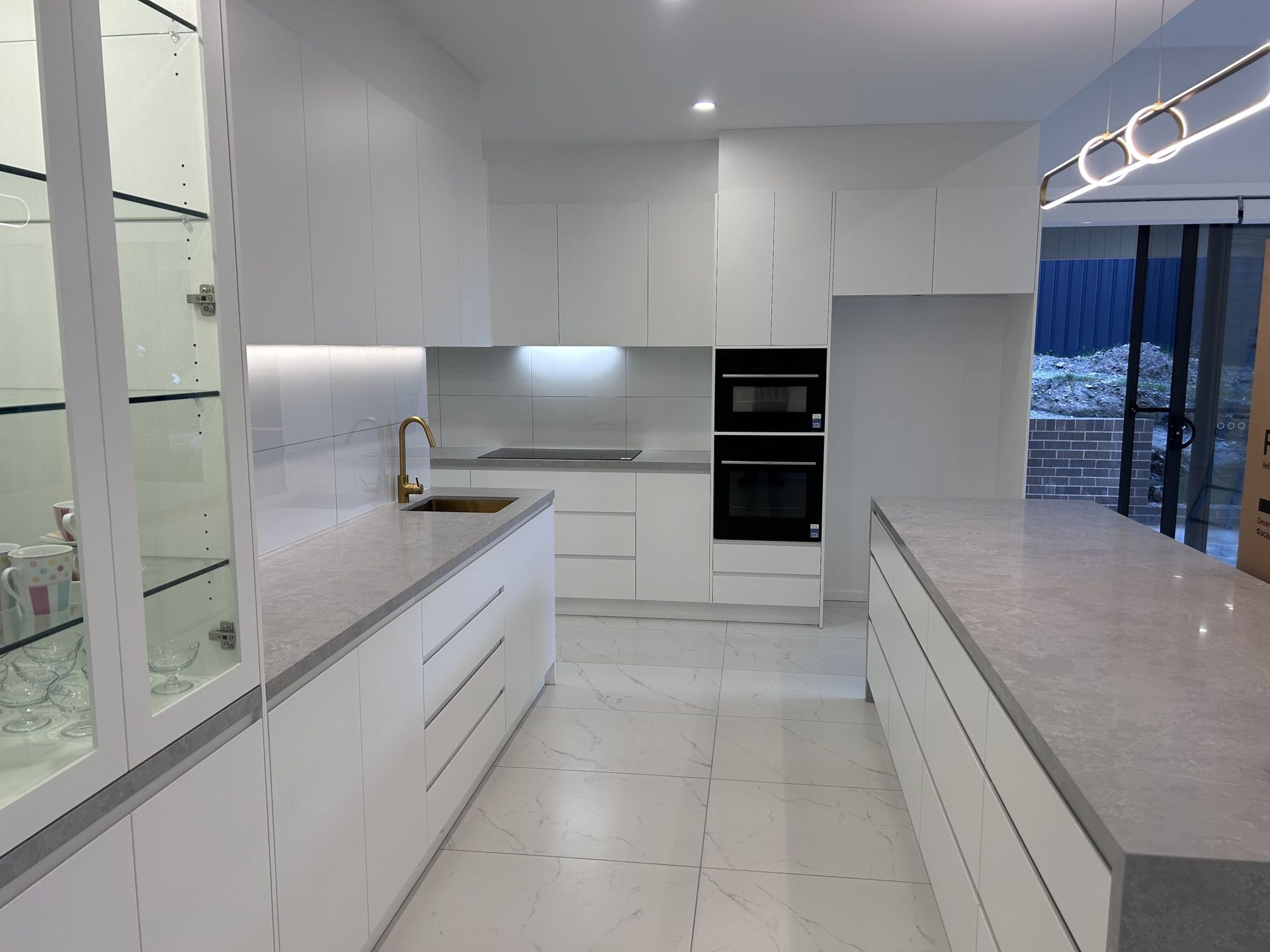 A kitchen with white cabinets and granite counter tops