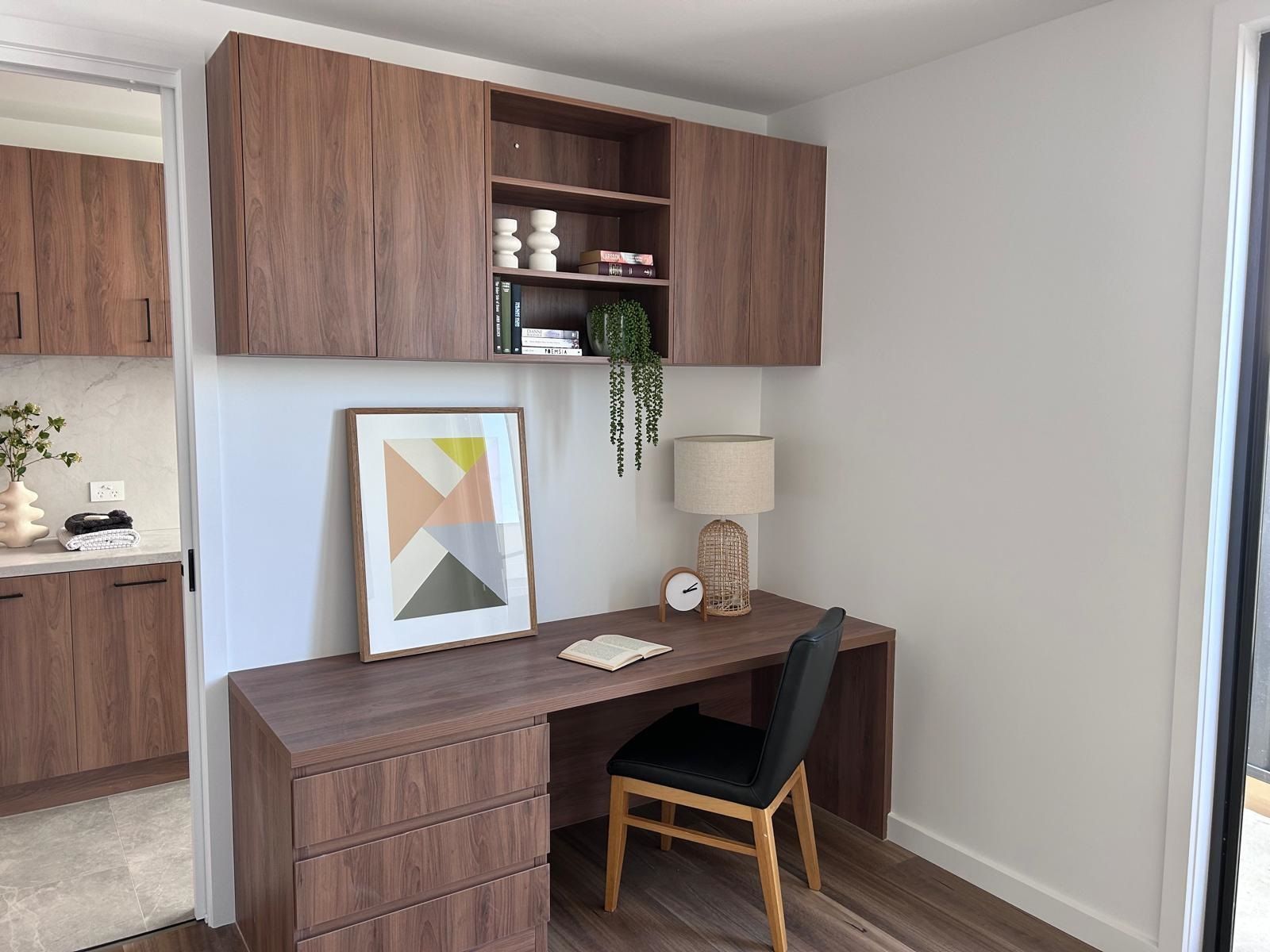 There is a desk and chair in the corner of the room.