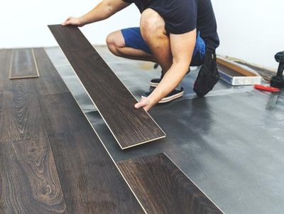 Man Installing a Wood Flooring — Durham, NC — Jayk's LLC