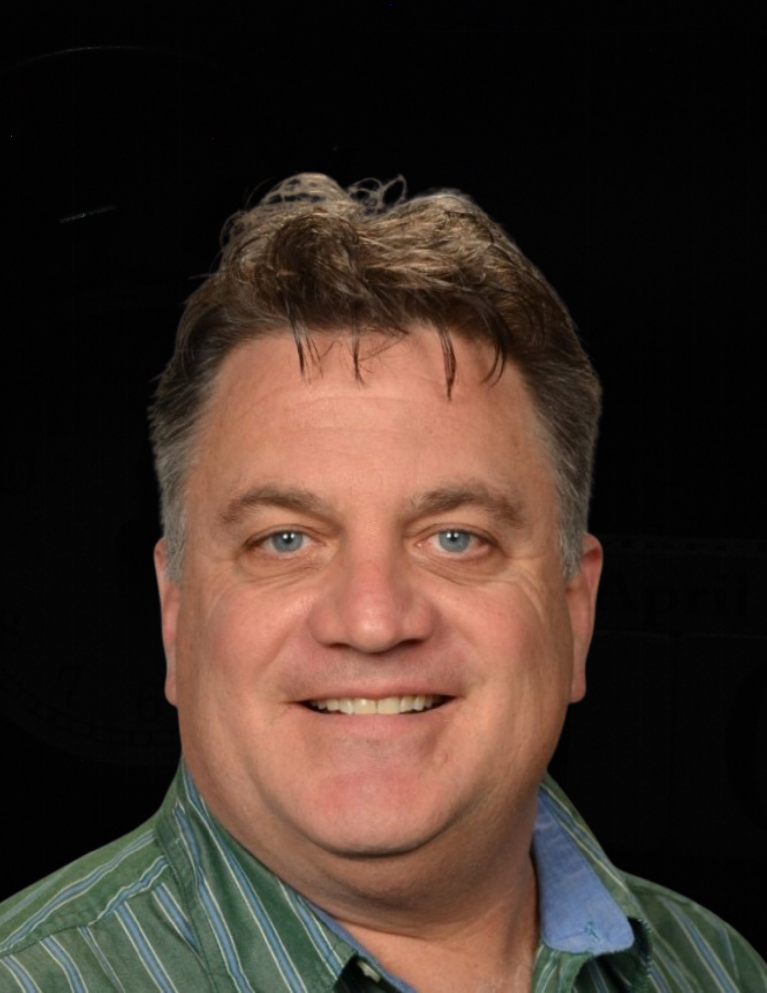 A man in a green striped shirt is smiling for the camera.