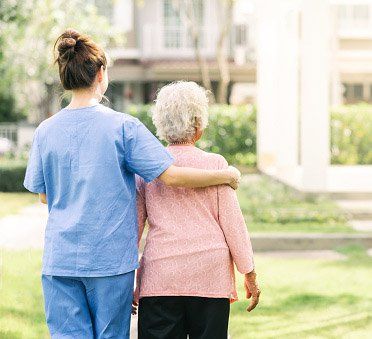 Caregiver Walking With Elderly Woman Outdoor — Vicksburg, MS — Washington Home Health Agency LLC