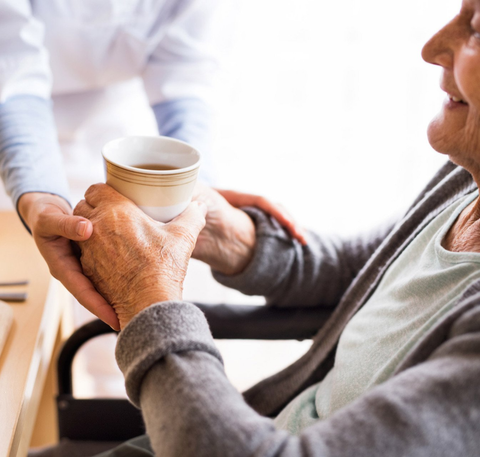 Care Giver Handling Coffee To A Senior Woman — Vicksburg, MS — Washington Home Health Agency LLC