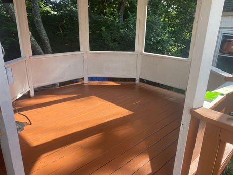 A gazebo with a wooden floor and a white roof.