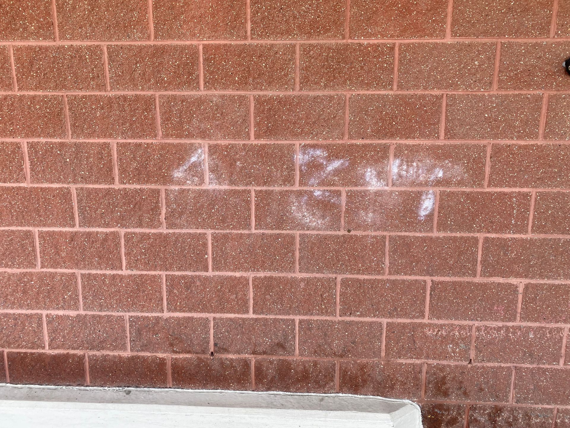 A brick wall with the word a on it