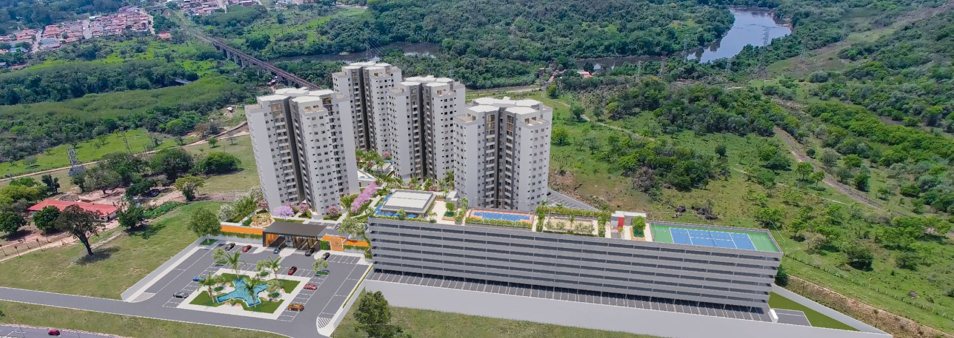 Vista aérea de um complexo residencial com edifícios altos, estrutura de estacionamento e área verde ao redor.