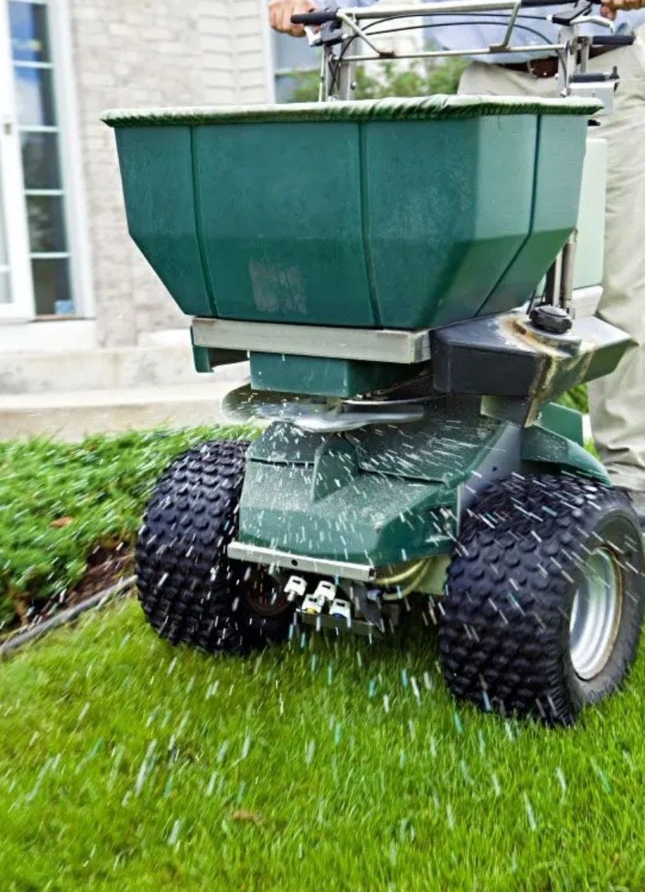 A Person Is Planting Flowers in A Pot on A Wooden Table | Clinton, OH | Flexlawn & Landscape, LTD