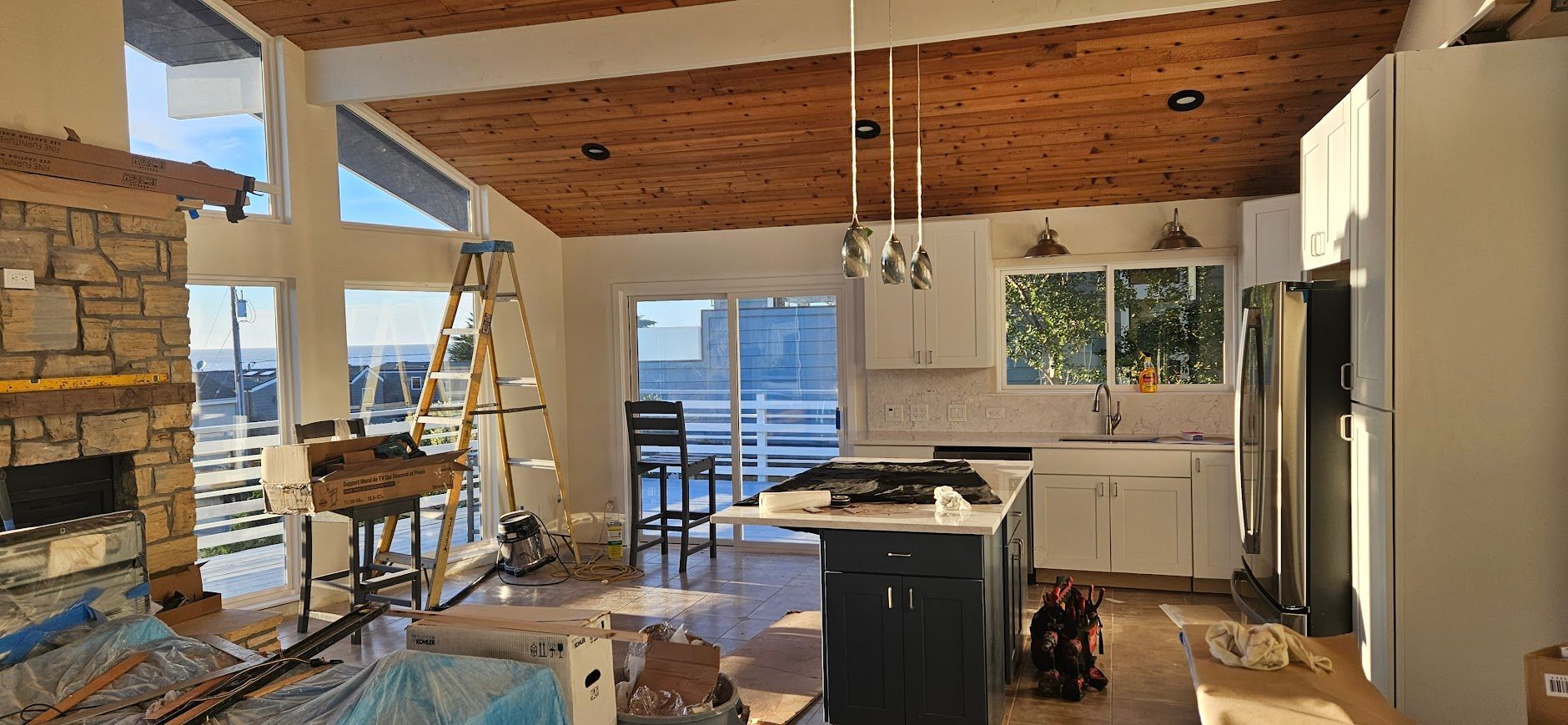 A kitchen and living room are being remodeled in a house.