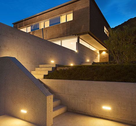 The stairs leading up to the house are lit up at night