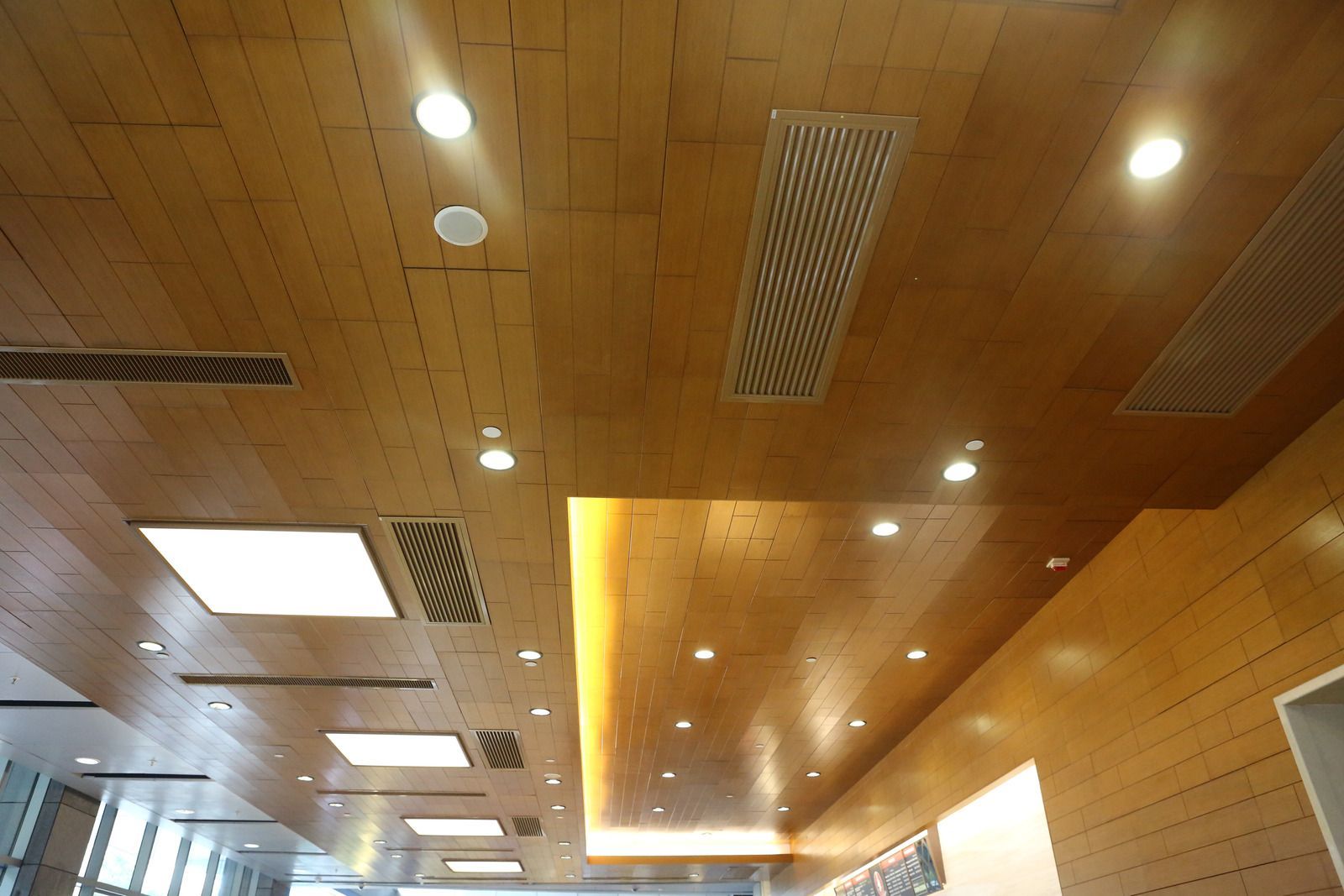A wooden ceiling with a lot of lights on it