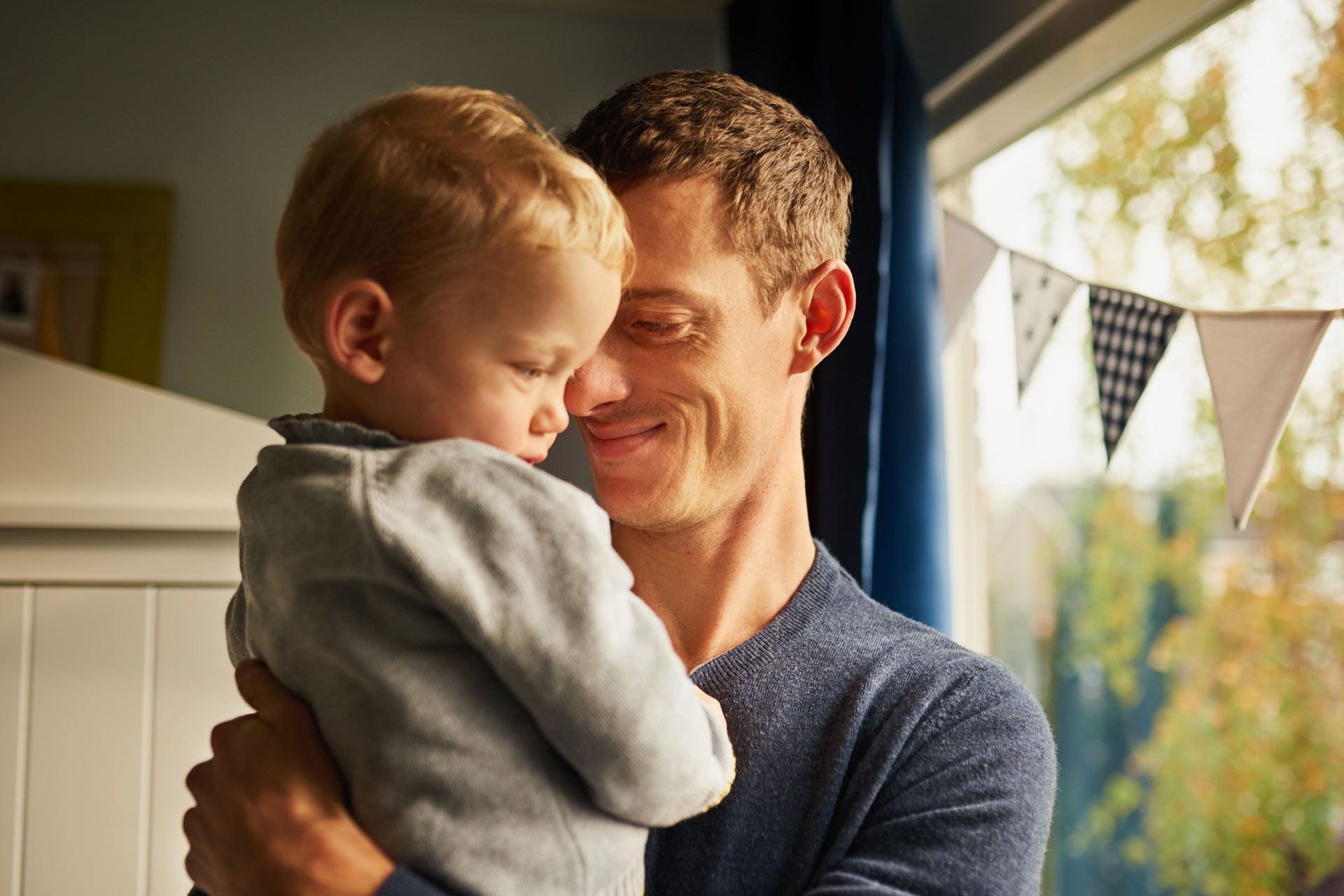 A man is holding a baby in his arms.