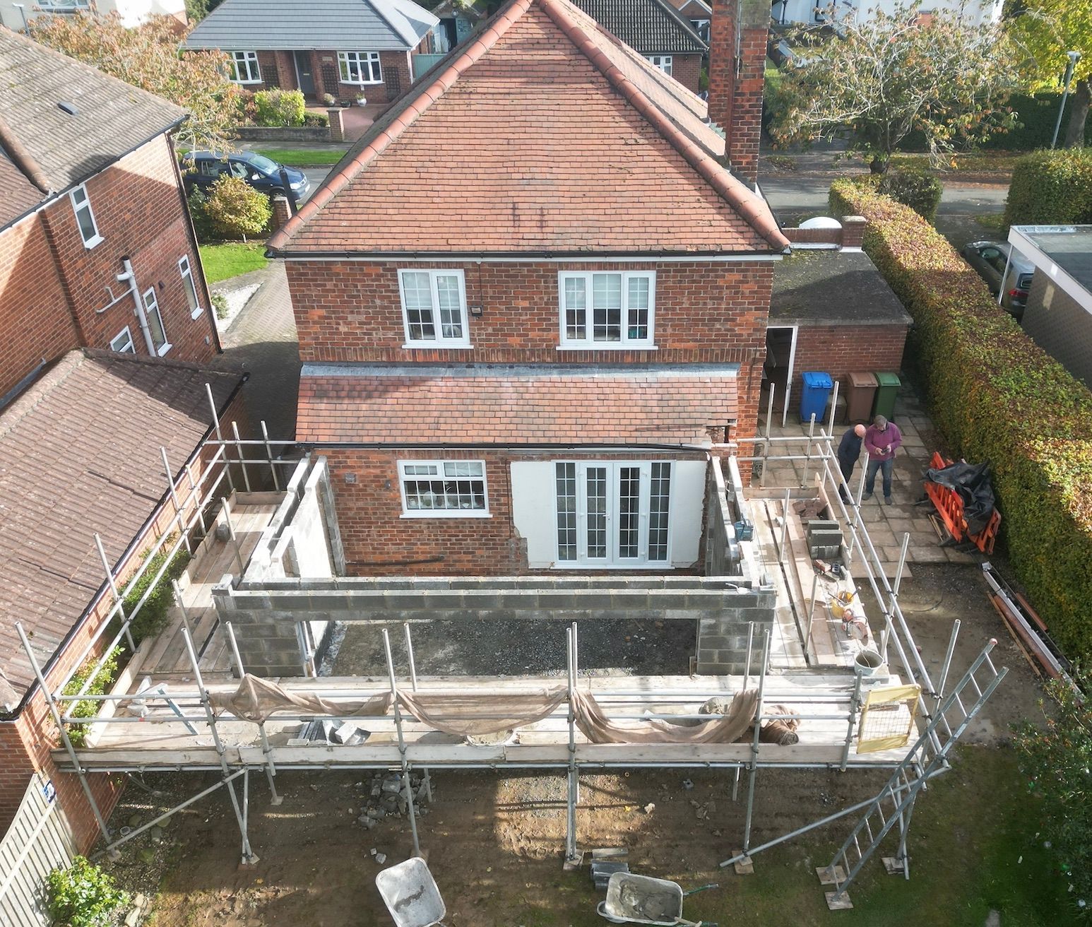 An aerial view of a house under construction with scaffolding around it