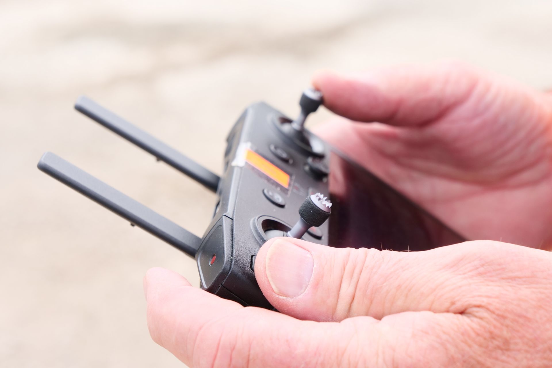 A person is holding a remote control in their hand.