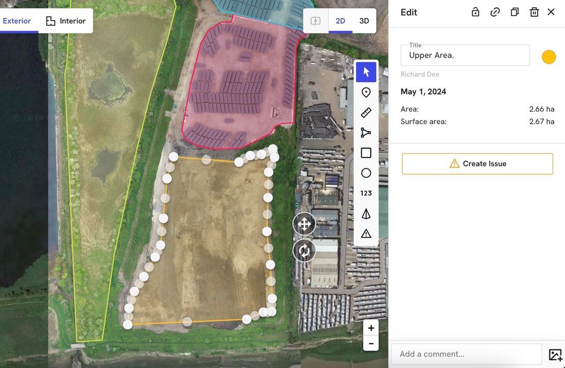 An aerial view of a large field with a lot of buildings in the background.