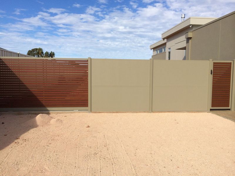A house with a fence and a gate in front of it
