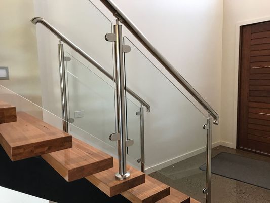 A staircase with wooden steps and a glass railing