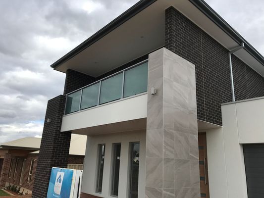 A house with a balcony and a sign that says ' a ' on it
