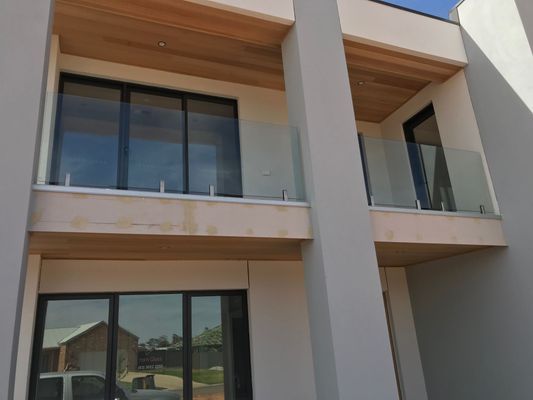 A house with a lot of windows and a balcony