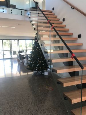 A staircase with a christmas tree in the background