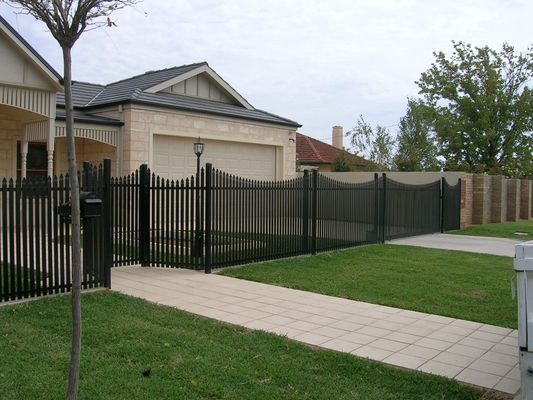 A house with a black fence surrounding it